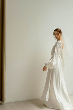 a woman in a white wedding dress and veil