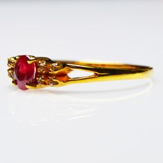 Natural Red Ruby Anniversary Ring {Natural African Treated Ruby} Pigeon Blood Ruby Dimension Of the stones {Ruby} : 4 x 5 mm Oval Shape 0.45 Ct total weight of the stones Secondary Stones : Natural White Zircon {8 Pcs 1.3mm Round } Whole Ring Weight : 1.56 g . Ring Size : UK O1/2, US 8 . Handcrafted with solid 9 K fine Gold . The band for Girl/Women individually hand-set with 4x5 mm size stone Oval shaped Natural Ruby July Birthstone birthstone . Total 9 Gemstones - Cluster Setting . This Ruby 9K Beautiful ring is timeless and stylish. Every piece passes rigorous inspection. So you can buy with confidence. A fantastic gift for Engagement, Anniversary Gift, Christmas's Day, Birthdays, Graduation, Valentine's Day,Mother's Day If you have any question please message us . Thanks for stopping u Ruby Ring With Center Stone For Promise, Promise Ruby Ring With Round Cut Center Stone, Promise Ruby Ring With Center Stone, Oval Ruby Diamond Ring With Prong Setting, Promise Ruby Ring With Prong Setting, Ruby Birthstone Ring With Prong Setting For Formal Events, Ruby Birthstone Ring With Prong Setting For Formal Occasions, Ruby Solitaire Ring For Promise, Classic Round Ruby Promise Ring