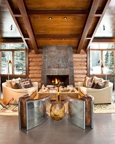 a living room with two couches and a fire place in the middle of it