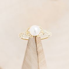 Product Details Ring Style: A dainty-style white Akoya pearl women's engagement ring with a floral-style band and diamond accents.... Pearl Ideas, Vintage Gold Engagement Rings, Ring Inspo, Dainty Style, Pearl Engagement Ring, Cute Engagement Rings, Staghead Designs, Future Engagement Rings, Ring With Diamond