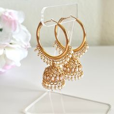 "Add a glamourous twist to your ordinary golden hoops with these classic bali jhumkas! These earrings come in a beautiful golden color with colored contrasting beads embellishing the hoops. Perfect for your casual occasions without going over the top! Length: 2.5\" | Width 1.5\" Items are carefully packed and ready for gifting. All pictures are taken in natural light please allow for slight variations in color due to camera settings. Jewelry Care ✨Protect your jewelry in a closed box or pouch   ✨Wear jewelry after you have applied lotion or perfume ✨Gently buff with a soft cotton cloth  Visit our website: www.desimoon.etsy.com Thank you for visiting and hope you enjoy my shop!" Luxury Gold Bridal Earrings For Diwali, Luxury Gold Plated Bollywood Jhumkas, Affordable Festive Temple Jewelry Earrings, Cheap Chandbali Earrings With Latkans, Luxury Elegant Jhumkas For Wedding, Luxury Ceremonial Jhumkas For Women, Cheap Bridal Earrings For Wedding And Diwali, Luxury Jhumkas For Diwali Rituals, Luxury Gold Dangle Jhumkas