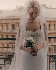 a woman in a wedding dress holding a bouquet