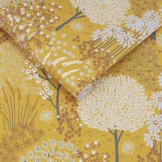 a yellow floral wallpaper with white flowers on it