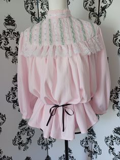 This lovely late Victorian/ early Edwardian style blouse is made from soft pink cotton-poly fabric trimmed with three kinds of lace, two kinds of ribbon, and tiny glass beads for a bit of sparkle. Size medium, fitting a 15" neck but loose at bust and waist, it is designed to puff out in the front when belted or tucked in, reflecting the style of 1890 - 1910. French seams, much hand stitching on trim and finishing, hooks and eyes at back and wrists. 3/4 sleeves are also decorated, gently gathered at shoulder and cuff. Black ribbon not included, just used to show belted look. Also looks good with modern clothing. Edwardian Blouse, Edwardian Style, Gibson Girl, French Seam, Edwardian Fashion, Style Blouse, Linen Trousers, Women's Costumes, Modern Outfits