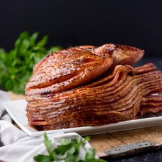 sliced ham on a white plate with parsley