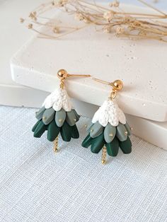 the green and white earrings are on display