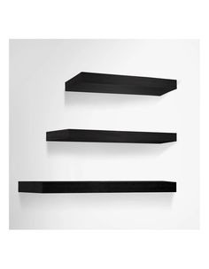 three black shelves on the wall