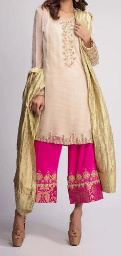 Color: Beige / Hot Pink/ gold Shirt: Chiffon  Pants: Silk  Duppata: Golden lama tissue  Embroidery: Golden Tilla , Pearls , Sequins and Tikki stones Gold Palazzo Set With Traditional Drape For Eid, Gold Palazzo Set For Eid With Traditional Drape, Festive Raw Silk Sharara With Gold Embroidery, Gold Palazzo Set With Zari Work Traditional Drape, Festive Sharara With Gold Embroidery In Raw Silk, Unstitched Festive Sharara With Gold Embroidery, Unstitched Sharara With Gold Embroidery For Festive Occasions, Unstitched Gold Embroidery Sharara For Festive Occasions, Bollywood Style Raw Silk Sharara With Gold Embroidery