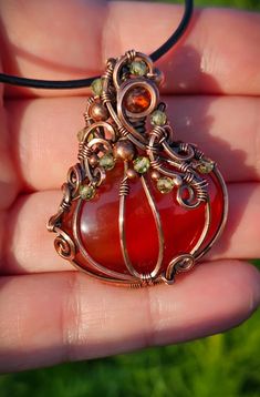 Handmade wirewrapped carnelian pumpkin pendant with peridot and Mexican fire opal accent beads, in pure copper wire, oxidized and polished for an antique look. Leather cord with adjustable slide knot and polishing cloth included  Any questions please ask :) thank you for looking! **photos taken in sunlight** Orange Wire Wrapped Handmade Jewelry, Orange Copper Wire Wrapped Jewelry, Unique Orange Wire Wrapped Jewelry, Orange Carnelian Wire-wrapped Jewelry, Fall Nature, Mexican Fire Opal, Autumn Nature, Pure Copper, Craft Inspiration