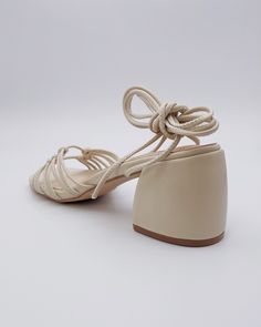 Chunky heel with knotted lace-up design. Meet Celia, the spring/summer season's sultry character. She's here to give your wardrobe the flirty, romantic feel it's been missing. For something special, lace up these beige strappy heels to be the style staple that defines your season. 2.5" heel 30.75" lace Man-made materials. Summer Season, Black Bird, Chunky Heel, Strappy Heels, Something Special, Chunky Heels, Spring Summer, Lace Up, Wardrobe