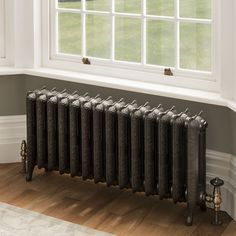 an old fashioned radiator in front of a window