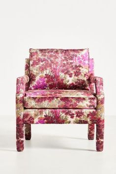 an upholstered chair with pink flowers on it