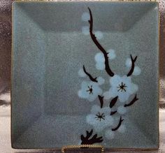 a glass plate with flowers painted on it