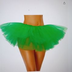 a woman's green tutu skirt is shown in front of a mannequin