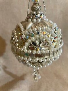 a glass ornament with pearls on it