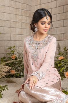 Blush Pink long silhouette shirt beautifully embellished with kamdani motives all over, cut work stylish zardozi work neckline & sleeves featuring silver dabka, sequins, pearls, beads, resham & tila embroidery, paired with pure atlas jamawar scalloped hand worked culottes & heavily kamdani embellished dupatta must have for engagement, nikkah and other Wedding Festivities Shirt Fabric: Georgette Shirt Length: 48” (customisable, mention in order notes) Culotte Fabric: Pure Atlas Jamawar Dupatta Fa Georgette Shirt, Zardozi Work, Designer Outfit, Wedding Festivities, Silhouette Shirt, Pakistani Designers, Shirt Fabric, Cut Work, Shirt And Pants