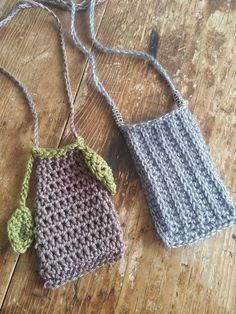 two crocheted bags sitting on top of a wooden floor