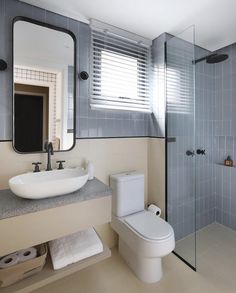 a bathroom with a sink, toilet and shower stall