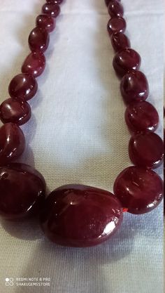 Awesome 398 Carat Fine Quality Natural Ruby Plain 21 Inch Necklace Adjustable code Stone :Natural Ruby Shape :- fancy oval Necklace - 21 inch 1 line string Size :- 5x7mm to 21x15mm Weight :- 398 carat Polish :- Handmade Purity :- 100% Natural Gemstone color - red makes a great gift for your loved ones. It is known as the 'love stone' as the message it emits is the strong vibration of unconditional love, joy, warmth and healing. As quartz crystals are profound amplifiers of energy, it may help to Elegant Amber Gemstone Beads, Oval Single Strand Beaded Necklace As Gift, Oval Single Strand Beaded Necklace For Gift, Elegant Oval Beads Necklace With Stones, Natural Round Amber Gemstones, Oval Necklace With Natural Stones For Formal Occasions, Formal Oval Necklace With Large Stone, Elegant Necklaces With Oval Beads For Healing, Formal Oval Necklace With Stones