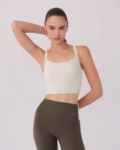 The SARA TOP in BONE by Nylora is a classic tank top made with their signature 4-way stretch rib fabric. Featuring an open back detail and a built-in shelf bra with removable padding, this top offers both style and functionality. Perfect for any active lifestyle, this top provides comfortable support and a flattering fit. DETAILS: Open back detail top Nylora's signature 4-way stretch rib fabric Built-in shelf bra with removable padding 77% Nylon, 23% Spandex Machine wash SIZE & FIT: Fits true to Sports Tank Top With Built-in Bra And Minimal Stretch, Sporty Top With Adjustable Straps And Strappy Back, Sporty Tops With Adjustable Straps And Strappy Back, Sporty Activewear With Removable Bra Pads And Strappy Back, Athleisure Bra Friendly Tops With Strappy Back, Athleisure Crop Top With Adjustable Straps, Athleisure Crop Top With Adjustable Straps For Yoga, Compressive Cross Back Top With Built-in Bra, High Stretch Athleisure Tank Top With Adjustable Straps