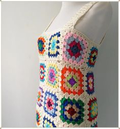 a crocheted tank top is displayed on a mannequin