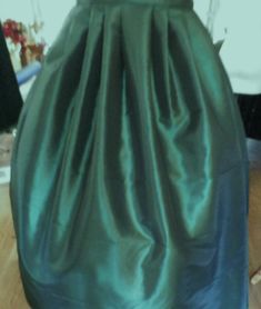 a woman's green dress is on display