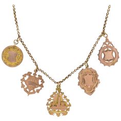 A stunning and bold medallion necklace with pieces from the Victorian (ca1880s) era! This lovely compilation piece is crafted in 9kt rose gold and adorns 5 beautiful and genuine medals hanging along the center of a lovely chain. Each decorative medallion is unique in design with three of the pendants graced with lovely yellow gold accents, adding a wonderful mixed metals appeal. The metals are all graced with elegant etching and some feature a wonderful raised shield motif at the center. The bac Gold Medallion Necklace, Horseshoe Pendant, Compass Pendant, Gold Medallion, Medallion Necklace, Yellow Gold Setting, Gold Brooches, Gemstone Necklace Pendant, Diamond Pendant Necklace