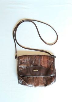 "Vtg leather and vegan leather (mixed materials) cognac brown patches 80s bag. Shoulder bag, crossbody purse. Patched adventure flap bag. The interior not lined, but inside are textile as leather bottom base. With 2 compartments and 1 zippered compartment inside. condition: Good vintage condition. No damages. The closure and zippers works well. Measures: Width 19 cm/ 7.4\" in Height 17,5 cm/ 6.8\" in strap length 119 cm / 46.4\" in" Brown Textured Leather Crossbody Flap Bag, Vintage Brown Crossbody Flap Bag, Vintage Textured Leather Crossbody Shoulder Bag, Vintage Brown Flap Bag For Travel, Brown Leather-backed Crossbody Flap Bag, Brown Leather Backing Crossbody Flap Bag, Brown Leather Backed Crossbody Flap Bag, Boho Leather Bags, Hipster Bag