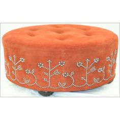 an orange ottoman with silver beading on it