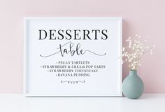 a sign that says desserts table next to a vase with baby's breath flowers