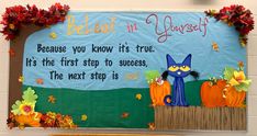 a bulletin board with an image of a blue cat and pumpkins on the front