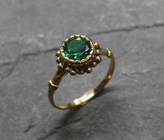 Gold Emerald Ring set with a Created Emerald in a perfect diamond cut, flawless clarity & deep green color, at 8mm diameter, weighting 2 Carats. Round Vintage Ring design made of Gold Vermeil ☞ thickest 18k Gold Plating on top of Solid 925 Sterling Silver ☞ made to last.☞ Choose your size ☞ I resize (before shipping) for FREE to Any size*Matching Earrings: www.etsy.com/listing/1056117887Matching Pendant - please ask me⌛Last Ring left ⌛ Details : ♥ Each item comes in a cute GIFT BOX ✓♥ GUARAN Green Diamond Rings, Gold Emerald Ring, Deep Green Color, Smaragd Ring, Vintage Gold Rings, Emerald Ring Gold, Antique Ring, Real Jewelry, Gold Ring Sets