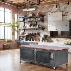 an industrial style kitchen with exposed brick walls and wooden floors, along with open shelving