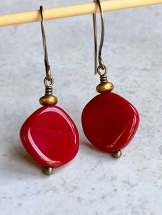 "deep red czech glass earrings boho dangle earrings for women These round-ish, opaque deep red discs are Czech glass beads. Sitting on top is a small, matte gold glass disc. Hook ear wires are antiqued brass. Length of earrings from top of ear wires is 1 1/2\". Red discs measure about 15mm, just over 1/2\". You can enter my shop here: gypsydangles.etsy.com" Leverback Earrings, Bohemian Earrings, Exeter, Purple Glass, Gold Glass, Earrings Boho, Brass Earrings, Bead Earrings, Glass Earrings