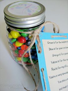 a jar filled with lots of candy next to a sign