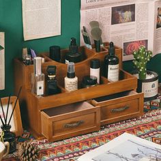 an assortment of beauty products are displayed on a table with books and other items in the background