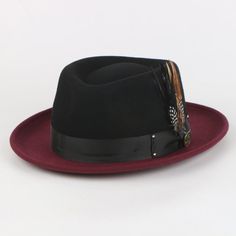 Introducing the Broadway Fedora, a masterclass in unique sophistication. Distinguished by its diamond-shaped crown, this hat makes a bold statement with its one-of-a-kind design. The contrasting crown and brim create a striking visual impact, while the matching removable feathers add an element of customization and flair. Perfect for those who seek to stand out with a touch of classic elegance, the Broadway Fedora effortlessly combines high fashion with distinctive style. Brim: 2 3/4th “(Snap Br