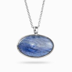 A rich blue stone with natural color banding and depth, this blue beauty will compliment any look. Kyanite is one of the few minerals that never need cleansing or clearing, as it does not retain any negative energy or vibrations. Wearing this gemstone aligns all chakras, bringing you tranquility and a calming effect to one's whole being. It is the perfect stone to facilitate meditation. Stone Origin: BrazilPlease Note: All pieces shipped within 48 hours from our Del Mar Gallery Measures Approxim Silver Necklace With Large Oval Cabochon Stone, Sterling Silver Necklace With Large Oval Stone, Oval Sterling Silver Necklace With Large Stone, Spiritual Sterling Silver Oval Necklace, Sterling Silver Oval Pendant Necklace With Cabochon, Sterling Silver Cabochon Oval Pendant Necklace, Oval Sterling Silver Necklace With Cabochon, Spiritual Oval Cabochon Gemstone Necklaces, Spiritual Oval Cabochon Necklace