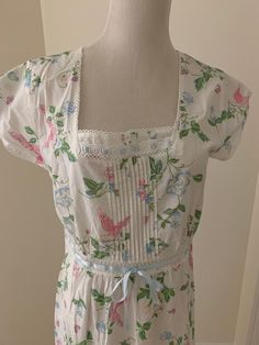 Beautiful vintage Laura Ashley nightgown tagged size small.  Florals and bird print against a white background.  Cap sleeves. Please use measurements.  Bust flat armpit to armpit is 17 inches Length is 46 inches from top of shoulder to edge at bottom 3.25 inch ruffle around bottom Ribbon detail at bodice front. Delightful and no issues to note!  No returns!  Final Sale!  Sold as is!  Please be sure of fit before purchasing and please ask questions if needed! Visit our Instagram page below! https White Floral Print Dress For Pajama Party, Floral Print Short Sleeve Dress For Pajama Party, White Floral Print Short Sleeve Sleepwear, White Floral Print Sleepwear With Short Sleeves, Fitted White Floral Print Sleepwear, Spring Floral Print Short Sleeve Nightgown, Pink Floral Print Short Sleeve Nightgown, Pink Floral Print Nightgown With Short Sleeves, Fitted Feminine Floral Print Nightgown