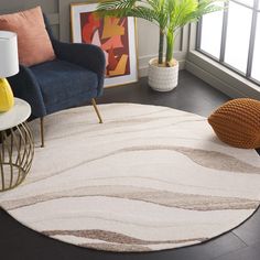 a living room area with a rug, chair and potted plant