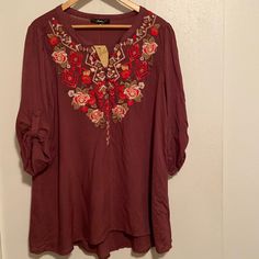 Size M. Maroon/Plum Colored Rayon Tunic Length Blouse. Embroidered Floral Boho Design Across Chest. Rolled Button Tab Sleeves. Notched V-Neck With Small Buttons. Split Hem. Nwt. No Rips, Stains Or Defects Known. Width Armpit To Armpit 20” Length 29” Style: Boho, Bohemia, Bohemian, Floral, Embroidered, Fall, Leggings & Boots, Lightweight, Boutique, Country, Autumn, Fall Embroidered Rayon Blouse, Fall Floral Embroidered Rayon Blouse, Fall Floral Embroidery Rayon Blouse, Country Autumn, Leggings Boots, Tunic Style Tops, Long Tunic Tops, Fall Leggings, Bohemian Colors