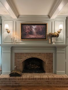 a fireplace with a painting on the wall above it