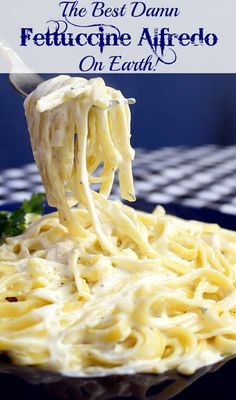 a fork full of pasta being lifted from the plate