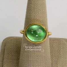 This designer J.Hengen ring features a glowing green beryl cabochon set in 18k solid gold.Ring Size: 6.75Total Weight: 11.78 gramsPrecious Metal: 18k solid goldPrecious stones:-Green Beryl Center Stone: 12 carats, 15mm x 13mmHallmark: J Modern Green Cabochon Rings, Green Emerald Ring With Oval Cabochon Bezel Setting, Green Oval Cabochon Ring With Bezel Setting, Modern Yellow Gold Emerald Cabochon Ring, Gold Emerald Cabochon Ring For May Birthstone, Estate Rings, Platinum Diamond Rings, Brooch Bouquets, Diamond Cocktail Rings