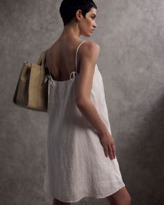 Hello, chic-at-the-beach style. Lightweight & effortless, our 100% European Linen Spaghetti Strap Mini Dress works great as a beach coverup or everyday dress. Pictured here with our 100% Organic Canvas Large Tote. Summer Linen Dress With Square Neck, Summer Brunch Linen Dress Relaxed Fit, Summer Linen Dress For Brunch With Relaxed Fit, Square Neck Linen Dress For Daywear, White Linen Dress With Tie Back, Casual Linen Square Neck Dress For Summer, Casual Linen Dress With Square Neck For Summer, Linen Dress With Straight Neckline For Vacation, Casual Linen Dress With Square Neck For Brunch