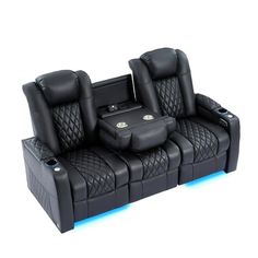 a black leather reclining couch with two seats and an electronic device on the back