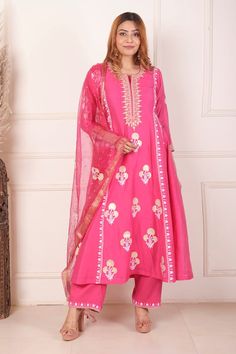 Rani pink chanderi anarkali featuring all over block printed floral motifs highlighted with dori embroidery. Comes with palazzo and dupatta.
Components: 3
Pattern: Block Print, Embroidered
Type Of Work: Floral, Dori
Neckline: Notched
Sleeve Type: Three quarter
Fabric: Anarkali: Chanderi, Palazzo: Cotton, Dupatta: Organza 
Color: Pink
Other Details: 
Length:
Anarkali:  48 Inches
Palazzo: 38 Inches
Dupatta: 2.5 Mtr 
Occasion: Sangeet,Mehendi and Haldi - Aza Fashions Designer Chanderi Sets In Pink, Pink Chanderi Designer Sets, Pink Chanderi Sets For Designer Wear, Pink Traditional Wear With Gota Work For Designer Occasions, Eid Pink Kurta With Dabka Work, Pink Bollywood Style Kurta For Festivals, Festive Pink Kundan Sets, Pink Kurta With Zari Work In Traditional Drape, Pink Chanderi Sharara With Zari Work