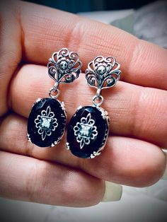 Faux Black Onyx Solid Sterling Silver Earrings Edward Embellished Design#E70e This is a pair of antique-inspired Edwardian style earrings. The flawless oval simulated black onyx gems are surrounded by delicate sterling silver filigree. The lovely full cut oval stones are approximately 14mm x 10mm. In the middle of each earring there lies delicate filigree surrounding a centered inset gem. Please choose white CZ (cubic zirconia), Lab Moissanite, or genuine diamond for the inset gem. The earrings Antique Silver Jewelry, Edwardian Jewelry, Edwardian Style, Nature Earrings, Gem Diamonds, Moissanite Earrings, Onyx Earrings, Sterling Silver Filigree, Antique Inspiration