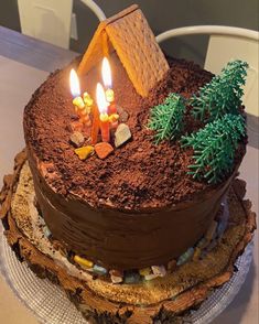 there is a cake that has candles in the shape of a house on top of it