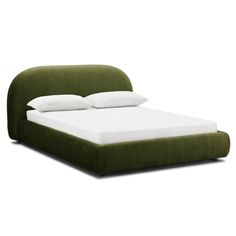 a green bed with white pillows on it and a headboard made out of fabric